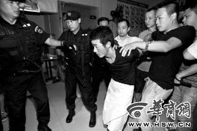 犯罪嫌疑人韓牙某圍著圍裙在廚房內(nèi)拉面，被民警抓獲 本報記者 鄧小衛(wèi) 攝