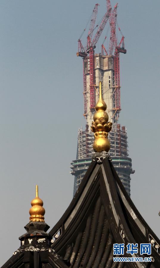 正在建設(shè)中的“上海中心”與豫園地區(qū)的傳統(tǒng)建筑（前）（4月11日攝）。