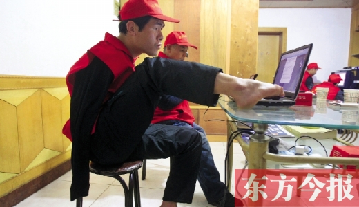 12月2日，一名“豫殘聯(lián)盟”志愿者正通過網(wǎng)絡(luò)、微博等聯(lián)絡(luò)著各地殘疾人朋友 東方今報首席記者 張曉冬