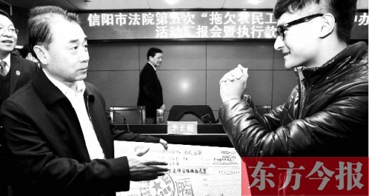 張立勇將依法執(zhí)行回來的農(nóng)民工工資發(fā)放給案件當(dāng)事人游昌華，游昌華施以中國傳統(tǒng)作揖禮答謝