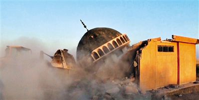 ISIS武裝人員駕駛推土機推倒一座清真寺的墻體。