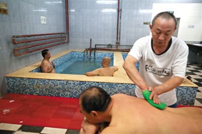 客人在搓澡。近日，百年歷史的鑫園浴池宣布將關(guān)張。新京報(bào)記者